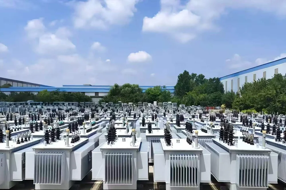 Rows of distribution transformers in a factory yard